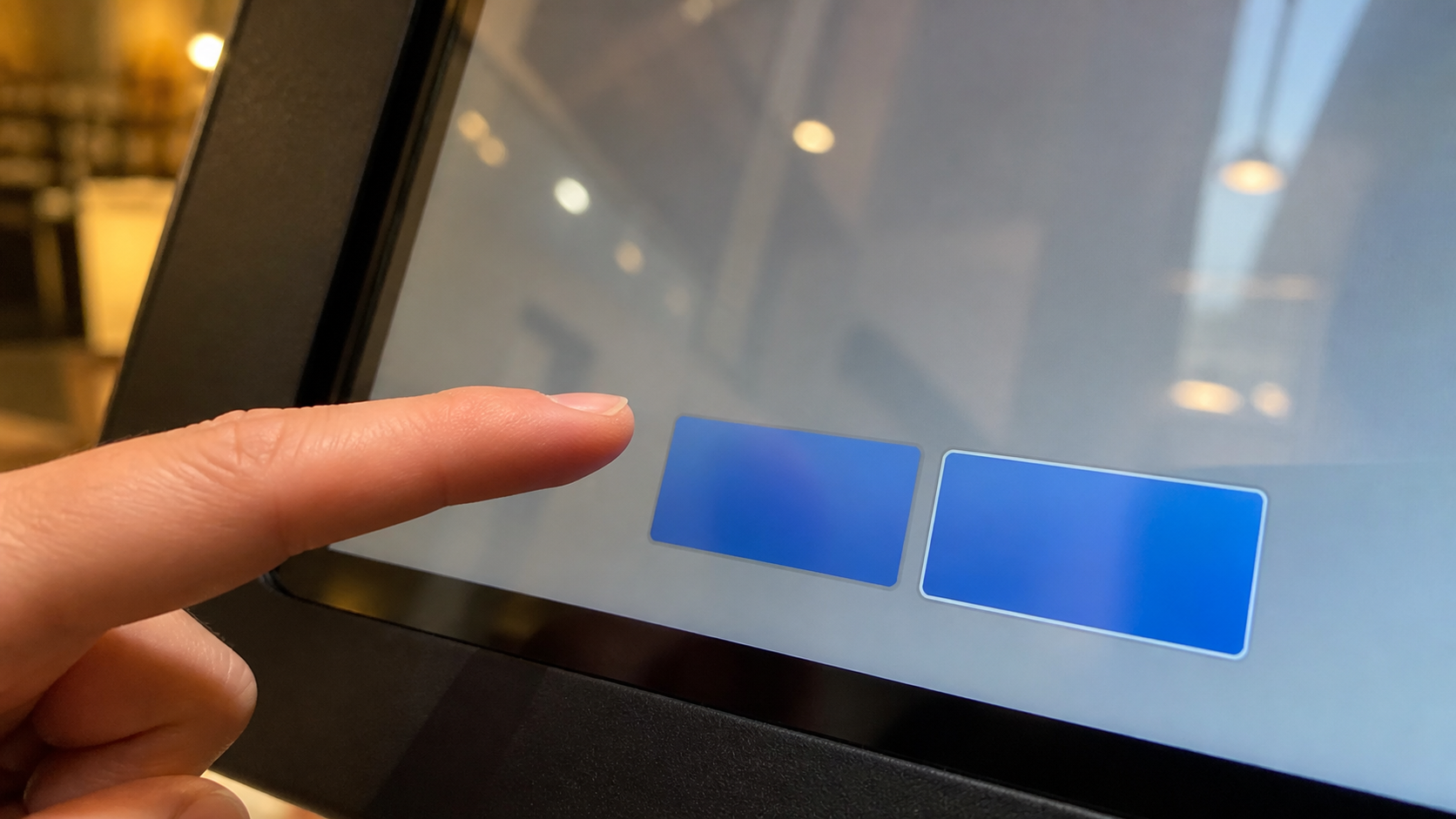 A finger hesitates between two nearly identical blue touch-screen buttons on a generic kiosk